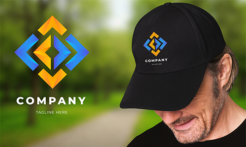 Man in black cap with colorful diamond logo; COMPANY and TAGLINE HERE text, park background