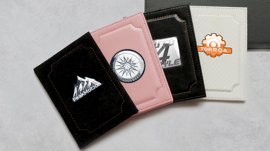 Four card holders with distinct logos: black with PeakModel mountain, pink with compass, black with Auto 4 Style plate, white with TORRQA gear
