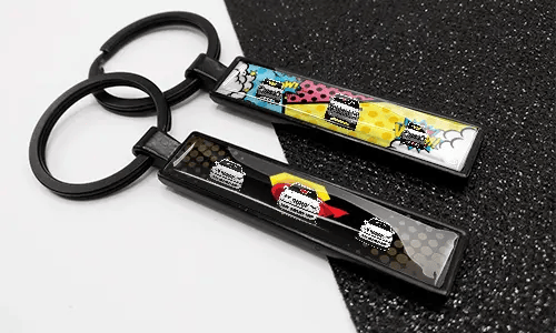 Comic-style license plate keychains featuring colorful designs and car illustrations
