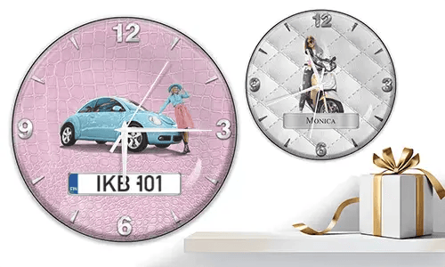 Two wall clocks with female figures and vehicles: left with black car on purple waves, right with red and black cars, racing flags, and blue background