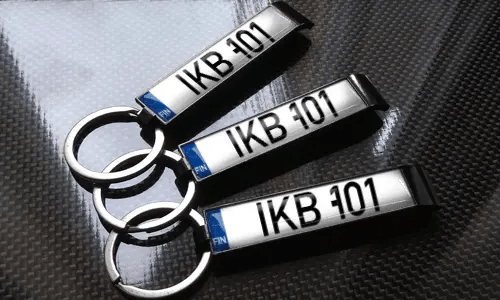 three bottle opener keychains with flags